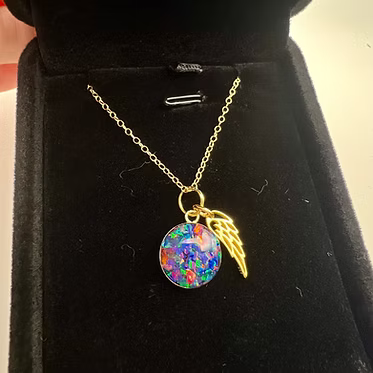 gold angel wing necklace in jelwery box 
