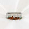A silver-toned band ring featuring an inlaid mountain landscape design with green, orange, and brown stones, set against a white background.