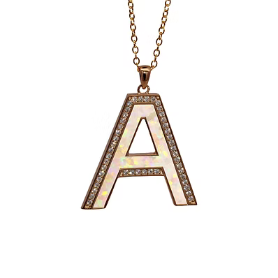 A rose gold letter 'A' pendant necklace with a white opal inlay and clear crystal accents, hanging from a matching rose gold chain against a solid white background.