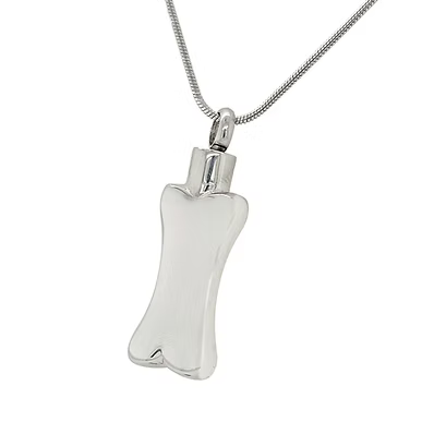 A polished silver cremation urn pendant shaped like a bone, suspended from a silver snake chain against a plain white background.