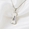 A silver bone-shaped pendant necklace engraved with the name 'Max' in black script, resting on a soft white satin fabric background.