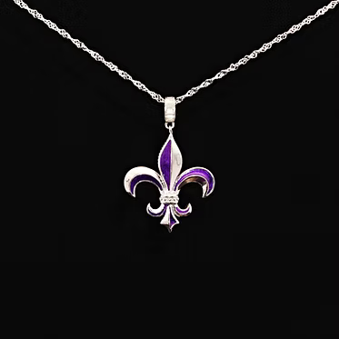 A silver-tone necklace featuring a fleur-de-lis pendant with purple enamel inlay, displayed against a solid black background.