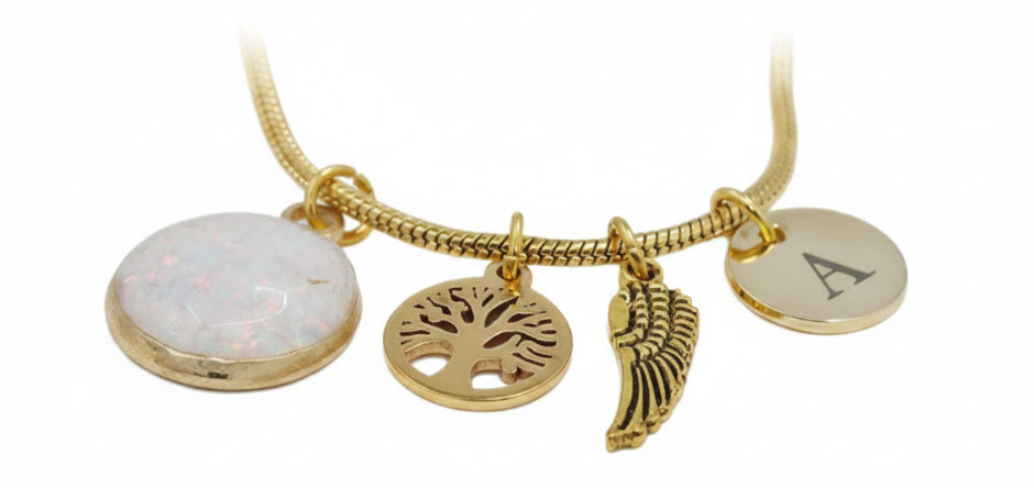 Gold necklace with various charms on a white satin background