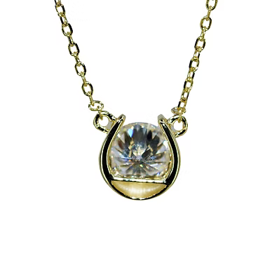 A gold necklace with a horseshoe-shaped setting holding a round clear faceted gemstone, shown against a plain white background.