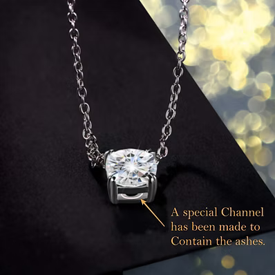 A silver necklace with a cushion-cut gemstone pendant on a black background, featuring a text overlay explaining a special channel to contain ashes.