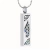 A silver-toned rectangular pendant necklace with a wing design and small blue and green inlaid details, hanging from a silver chain against a plain white background.
