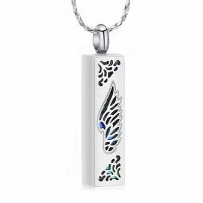 A silver-toned rectangular pendant necklace with a wing design and small blue and green inlaid details, hanging from a silver chain against a plain white background.