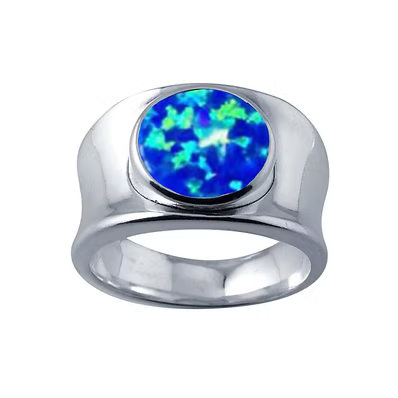 A silver-toned ring featuring a round cabochon opal gemstone with vibrant blue and green play-of-color, set against a plain white background.