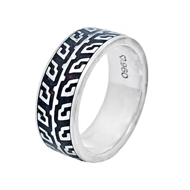 A sterling silver band ring featuring a black and white Greek key geometric pattern inlay, with a '925' silver purity stamp visible on the inside.