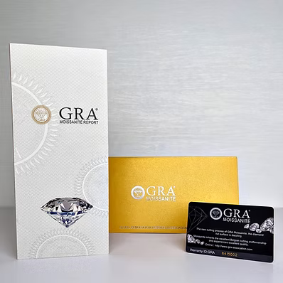  GIA (Graded & Certified International) diamond report packaging set, featuring a white textured report card, a gold certificate envelope, and a black diamond certification card on a light gray background.