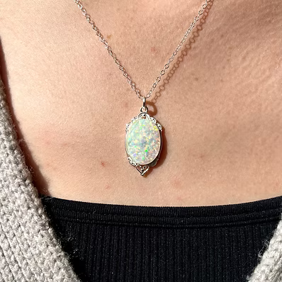 Mini victorian Pendant in .960 Argentium Silver. featuring a custom opal and ash inlay on an 18-inch chain.